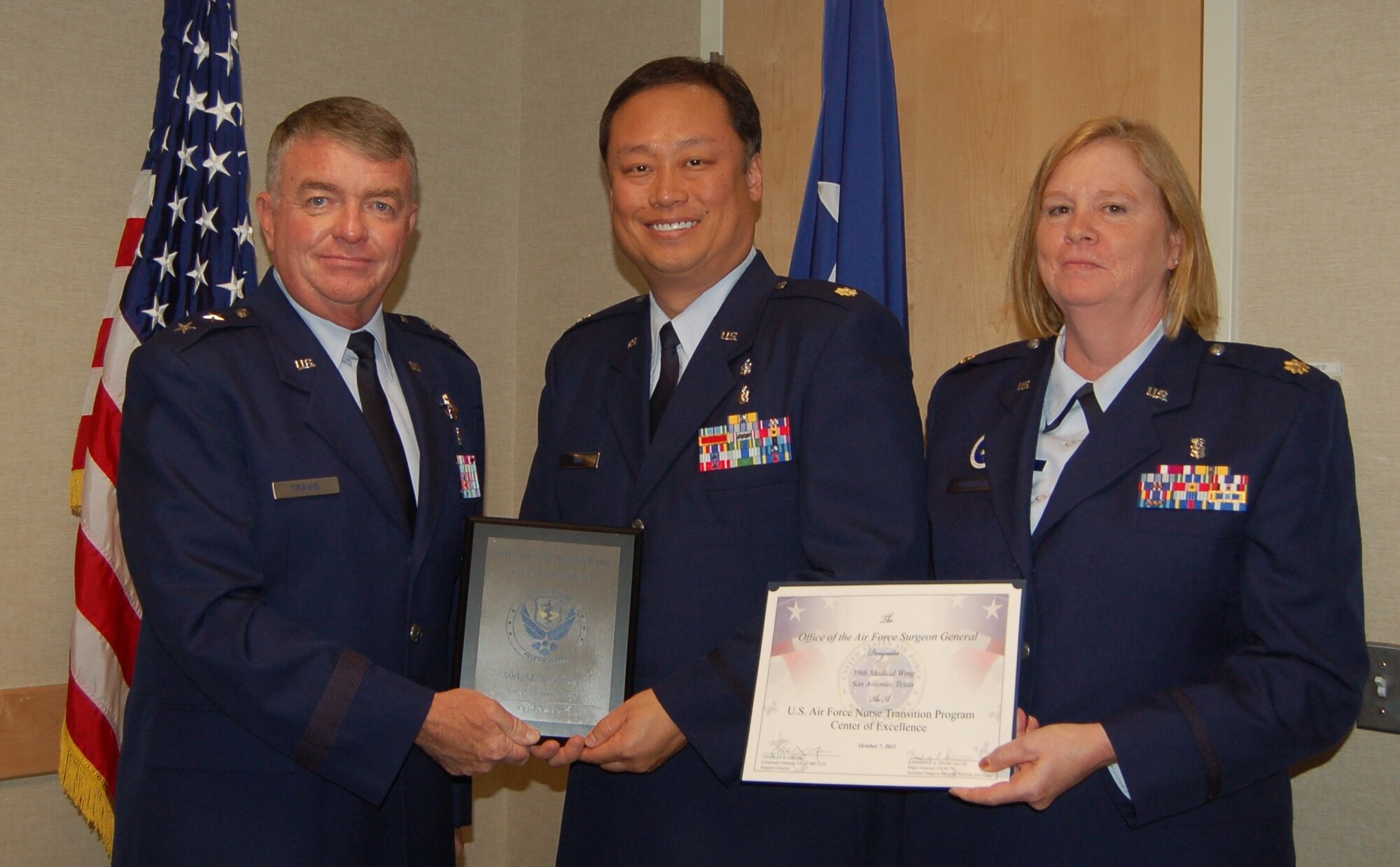 Maj. Gen. Thomas Travis, Deputy Surgeon General, recognizes  Maj. Andrea Guerreo, Air Force Nurse Transition Program Director and Maj Chi Suh, SAMMC
NTP Course Supervisor at "Enhancing Partnerships Through Professional Collaboration" conference.  From left to right, Maj. Gen. Travis, Maj. Chi
Suh. (Air Force Photo)
