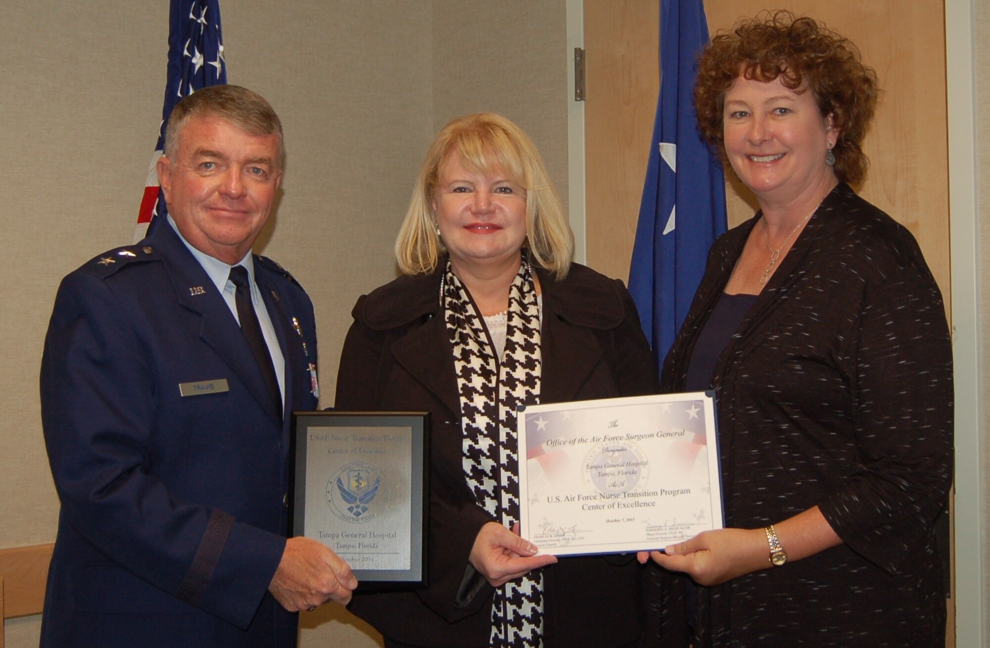 Maj. Gen. Thomas Travis, Deputy Surgeon General, presents Tampa General Hospital with Center of Excellence Award at "Enhancing Partnerships through Professional Collaboration" conference.  From left to right, Maj. Gen. Travis , Dr. Kathy Katz,  Senior Vice President & Chief Nursing Officer and Leah Godfrey, Director, Nursing Operations. (Air Force Photo)
