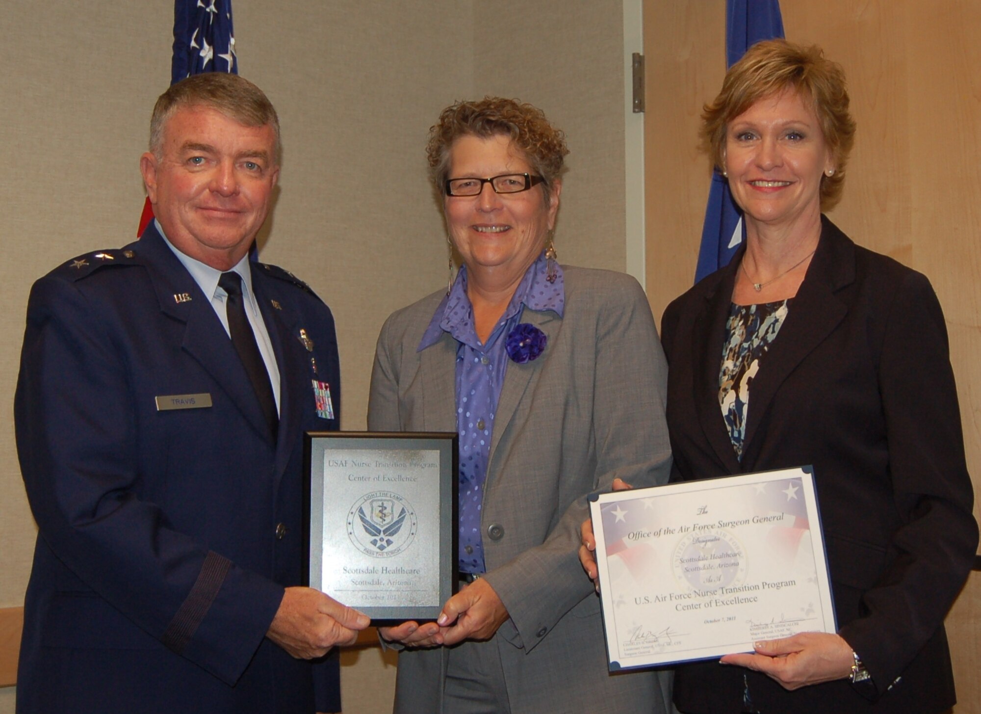 Maj. Gen. Thomas Travis, Deputy Surgeon General, presents Scottsdale Health Care with Center of Excellence Award at "Enhancing Partnerships Through Professional Collaboration" conference.  From left to right, Maj. Gen. Travis , Wendy Lyons, Vice President of Community Stewardship and Kathi Zarubi, Associate Vice President of Nursing Practice. (Air Force Photo)
