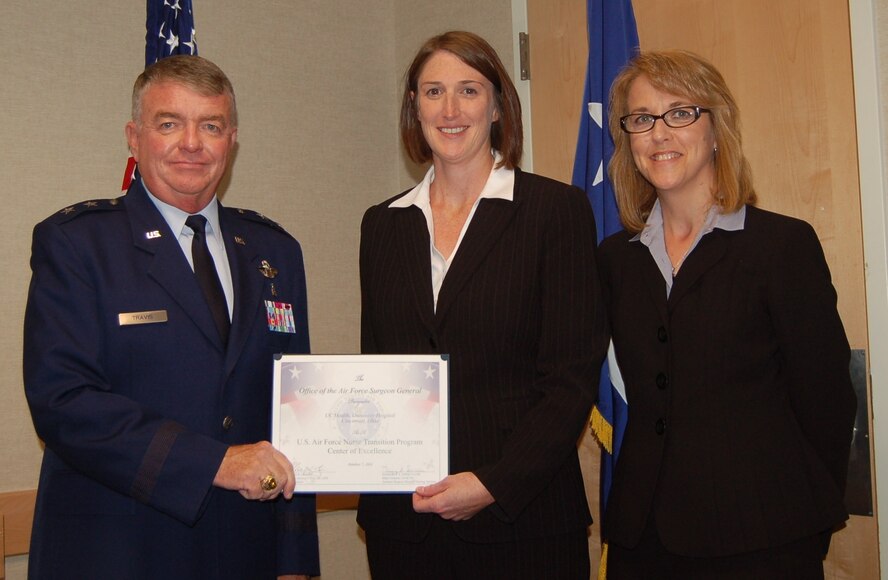 Maj. Gen. Thomas Travis, Deputy Surgeon General, presents University of Cincinnati  Health Hospital with Center of Excellence Award at "Enhancing Partnerships Through Professional Collaboration" conference.  From left to right, Maj General Travis Jennifer Jackson, Chief Nursing Officer, and Amy Costanzo, Manger, Professional Staff Education. (Air Force Photo)
