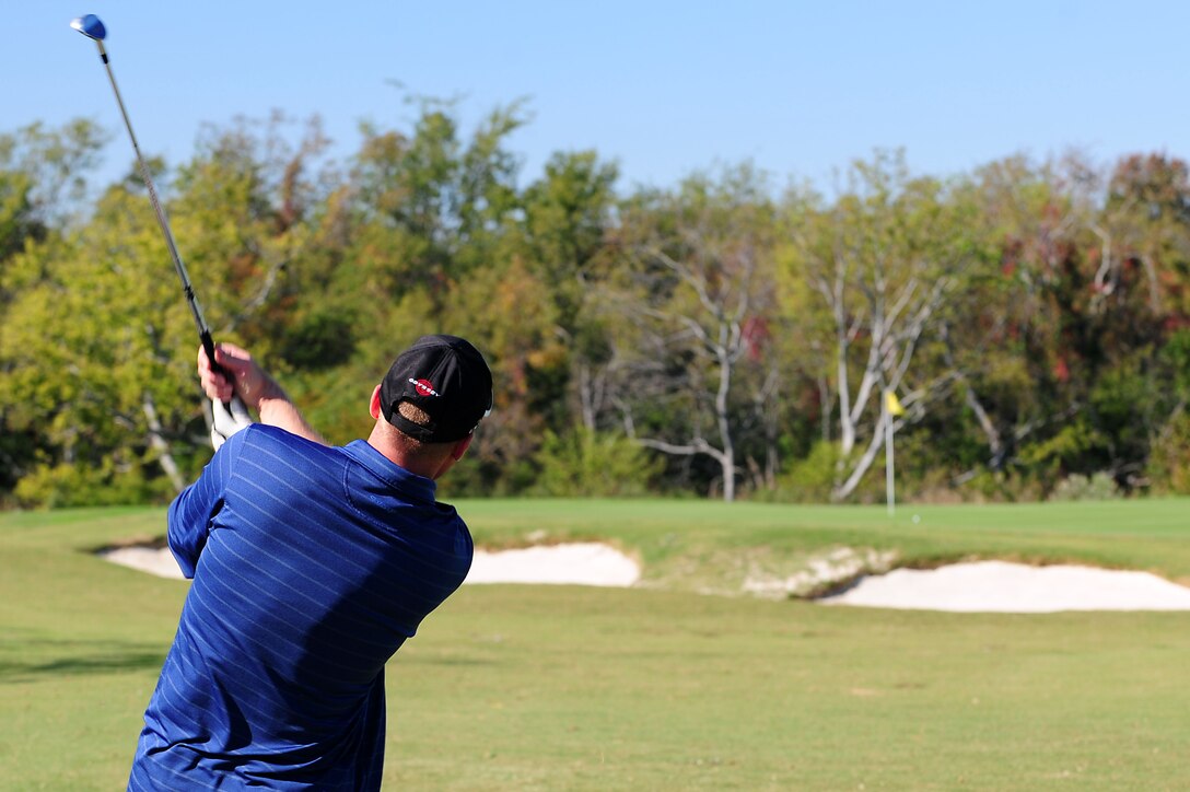 U.S. Air Force Tech. Sgt. Greg Styer, 633rd Air Base Wing Communications Squadron NCO in charge of network integration, swings and aims for the green during the Langley Chief's Group "Chief Mik" Golf Tournament at Langley Air Force Base, Va., Oct. 21, 2011.  Proceeds from the tournament benefit scholarship, award and morale programs for junior enlisted Airmen at Langley AFB.  (U.S. Air Force photo by Airman 1st Class Kayla Newman/Released)
