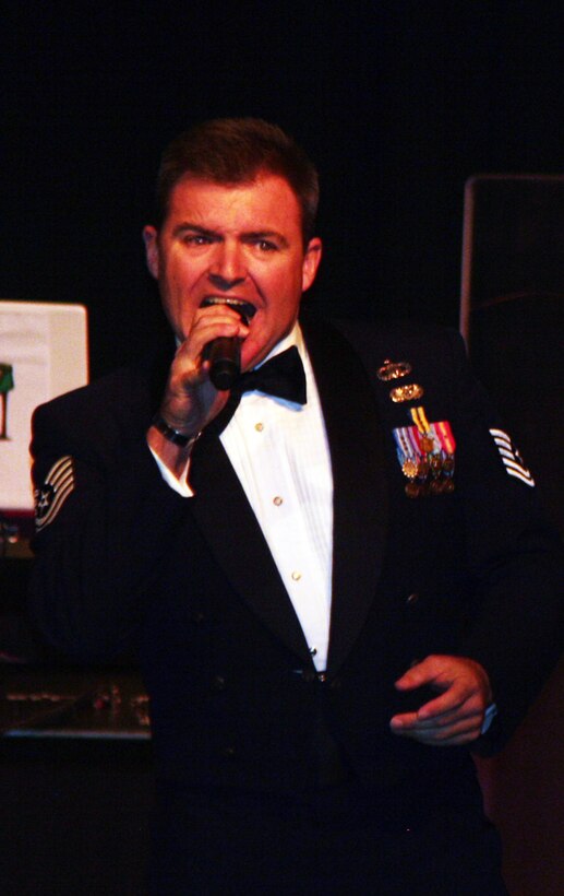 Tech. Sgt. Jamie Gilley, vocalist for the Starlifter band from the U.S. Air Force Band of Mid-America, sings during the 2011 Air Mobility Command Icon finals Oct. 20, 2011, at Scott Air Force Base, Ill. The Starlifter band played all of the music for the 10 competitors in the Icon competition. (U.S. Air Force Photo/Master Sgt. Scott T. Sturkol)