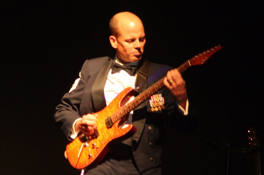 Master Sgt. Jerry Kelley, NCO in charge and lead guitarist for the Starlifter band from the U.S. Air Force Band of Mid-America, plays a tune during the 2011 Air Mobility Command Icon finals Oct. 20, 2011, at Scott Air Force Base, Ill. The Starlifter band played all of the music for the 10 competitors in the Icon competition. (U.S. Air Force Photo/Master Sgt. Scott T. Sturkol)
