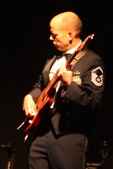 Master Sgt. Jerry Kelley, NCO in charge and lead guitarist for the Starlifter band from the U.S. Air Force Band of Mid-America, plays a tune during the 2011 Air Mobility Command Icon finals Oct. 20, 2011, at Scott Air Force Base, Ill. The Starlifter band played all of the music for the 10 competitors in the Icon competition. (U.S. Air Force Photo/Master Sgt. Scott T. Sturkol)