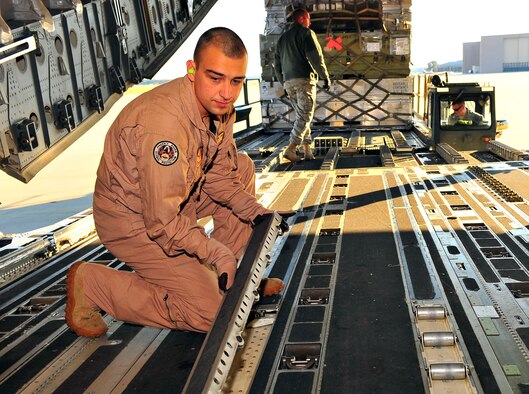 Senior Airman Michael Walier, 627th Air Base Group raven, returns rollers to their place in the cargo area of a C-17 Globemaster III Oct. 18, 2011, at Shaw Air Force Base, S.C. The C-17 carried U.S. Secretary of State Hillary Rodham Clinton to Tripoli, Libya, earlier this week. (Air Force photo/Airman 1st Class Neil D. Warner)

