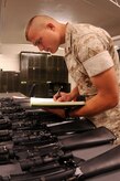 Corporal Timothy Earle conducts a monthly serialized weapons inventory in preparation for an upcoming overseas deployment. Earle is a Reservist assigned to the Marine Corps Reserve Training Command, 4th Landing Support Battalion, Charlie Company at Joint Base Charleston - Weapons Station. (U.S. Navy photo/Petty Officer 1st Class Jennifer Hudson)