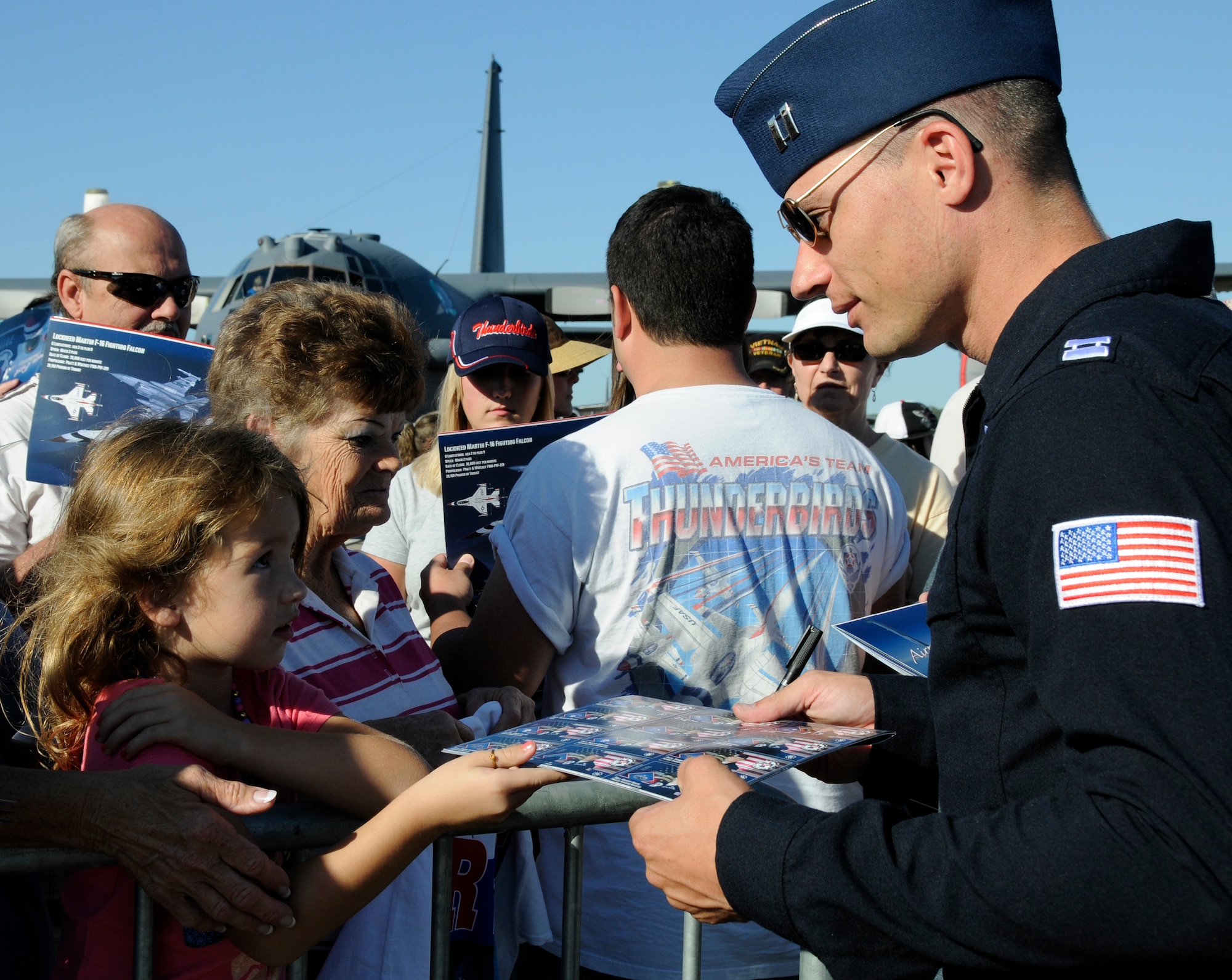 Capt. Nicholas Holmes, a pilot with the U.S. Air Force Thunderbirds, signs autographs
following a performance at the Fort Smith Air Show Oct. 1. (U.S. Air Force
photo by Airman 1st Class Hannah Landeros/188th Fighter Wing Public Affairs)