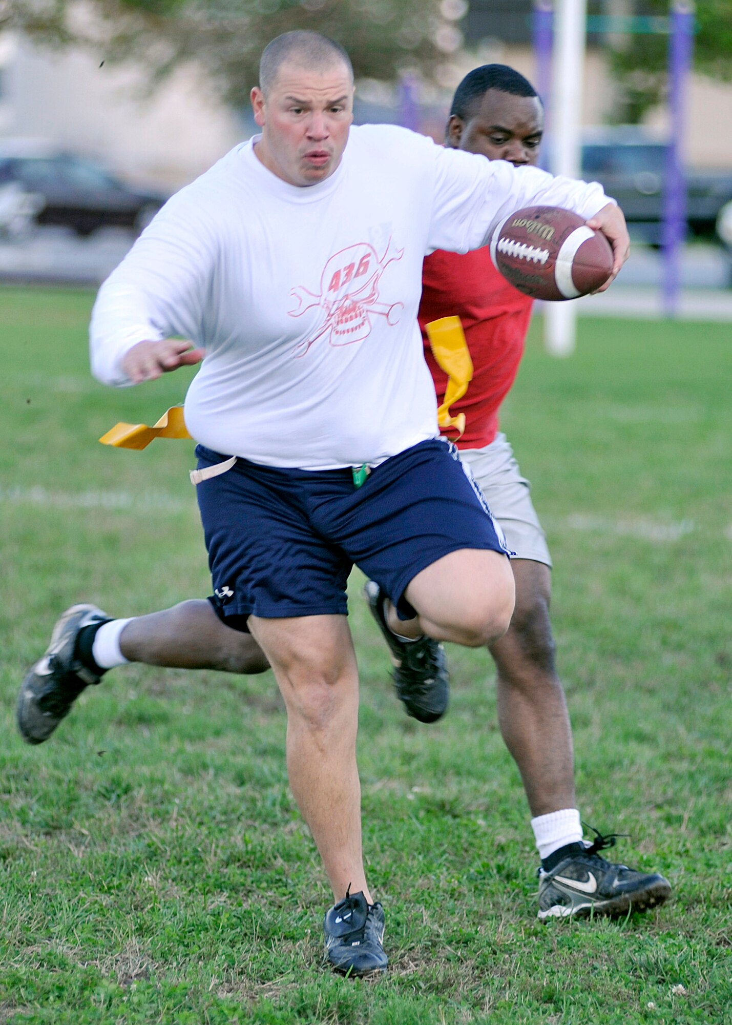 Nick Pieller, 436th Aircraft Maintenance Squadron, runs for a first down as a 436th Civil Engineer Squadron A team defender attempts to pull his flag during a National League flag-football game Oct. 20, 2011, at Dover Air Force Base, Del. The 436th AMXS remained unbeaten on the season with a 26-20 victory. (U.S. Air Force photo by Tech. Sgt. Chuck Walker)