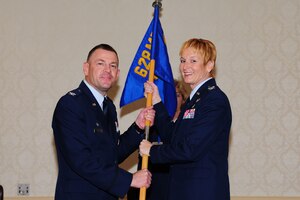 Col. Judith Hughes accepts the 628th Medical Group guidon from Col. Richard McComb during the 628th MDG change of command Oct. 21 at Joint Base Charleston. Hughes is the new 628th MDG commander and McComb is the Joint Base Charleston commander. (U.S. Air Force photo/Tech. Sgt. Chrissy Best)
