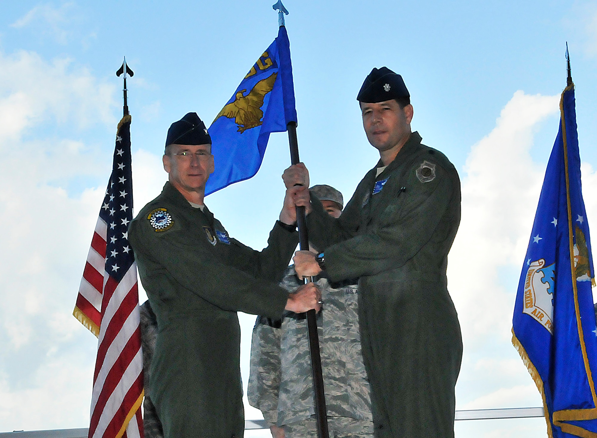 Col. Donald R. Lindberg, left, Commander, 482nd Fighter Wing passes the guidon to Lt. Col. Michael F. Hernandez, as he assumed command of the 482nd Operations Group on Oct 23.  Lt. Col. Hernandez will be responsible for all airfield and aircrew operations. (U.S. Air Force photo/Senior Airman Lou Burton) 