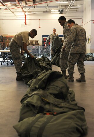 Airmen place Chemical-bags in the correct order at Joint Base Charleston - Air Base, Oct. 20, in preparation for the JB Charleston Operational Readiness Exercise. A C-bag is issued to deploying Airmen if there is a chemical-biological threat in the deployment area and contains two complete ground crew ensembles, M8/M9 paper and decontamination kits. (U.S. Air Force photo/Airmen 1st Class Ashlee Galloway)