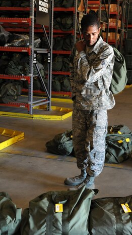 Senior Airman Deangelo Brundidge looks for a tag number while placing Chemical-bags in the correct order in preparation for the Operational Readiness Inspection at Joint Base Charleston - Air Base Oct. 20.   A C-bag is issued to deploying Airmen if there is a chemical-biological threat in the deployment area and contains two complete ground crew ensembles, M8/M9 paper and decontamination kits. Brundidge is from the 628 Logistics Readiness Squadron. (U.S. Air Force photo/Airman 1st Class Ashlee Galloway).