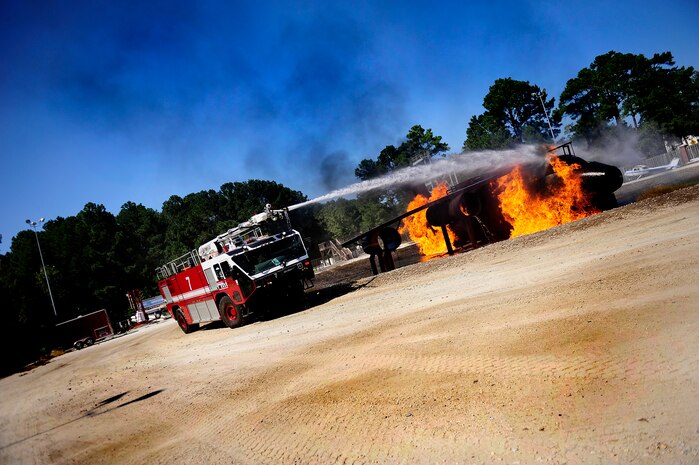 U.S. Air Force firemen begin to extinguish a burning aircraft during a training exercise at Joint Base Charleston - Air Base Oct. 5. ( U.S. Air Force photo/ Senior Airman Jeremy Burns)