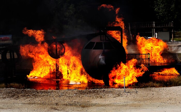 Flames poor out of a training aircraft during a training exercise at Joint Base Charleston - Air Base Oct. 5. The exercise allows Team Charleston fire fighters the ability to practice their fire-response abilities in case of an actual emergency. ( U.S. Air Force photo/Senior Airman Jeremy Burns)