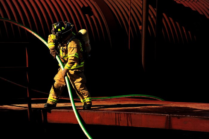 Senior Airman Anthony Ankeny prepares to respond to a simulated interior fire during a training exercise at Joint Base Charleston - Air Base Oct. 5. The interior burn inside the static training aircraft allows Team Charleston fire fighters the ability to practice their fire-response abilities in case of an actual emergency.  Ankeny is a fire fighter with the 628th Civil Engineer Squadron.   (U.S. Air Force Photo/ Staff Sgt. Clay Lancaster )