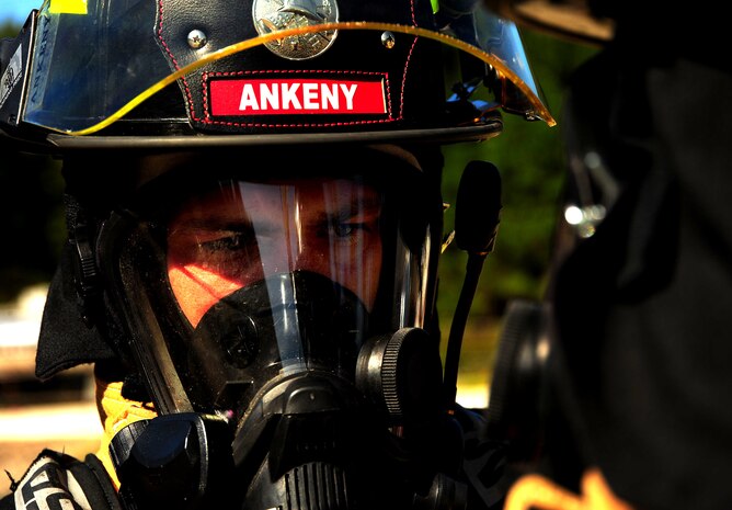 Senior Airman Anthony Ankeny gets ready to respond to a simulated interior fire during a training exercise at Joint Base Charleston - Air Base Oct. 5. The interior burn inside the static training aircraft allows Team Charleston fire fighters the ability to practice their fire-response abilities in case of an actual emergency. Ankeny is  a fire fighter with the 628th Civil Engineer Squadron. (U.S. Air Force Photo/ Staff Sgt. Clay Lancaster )