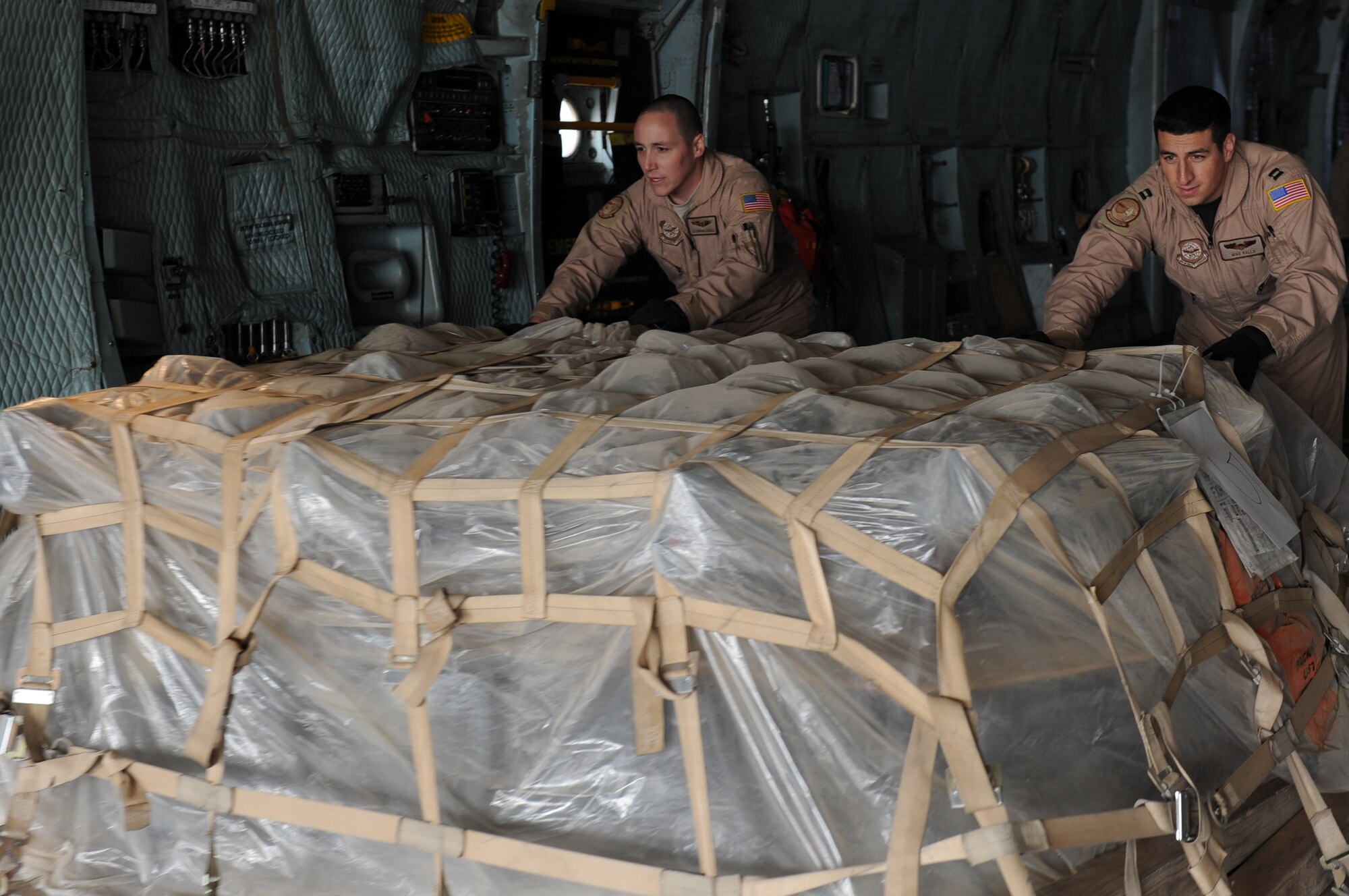 SPANGDAHLEM AIR BASE, Germany -- Airman 1st Class Stephan Lucadella, 9th Airlift Squadron loadmaster, and Capt. Michael Rallo, 9th Airlift Squadron pilot, Dover Air Force Base, Del., unload cargo from a C-5 Galaxy Oct. 24 on ramp 5. The cargo belongs to the 480th Fighter Squadron here who recently returned from a deployment to Iraq in support of Operation New Dawn. (U.S. Air Force photo/Airman 1st Class Brittney Frees)