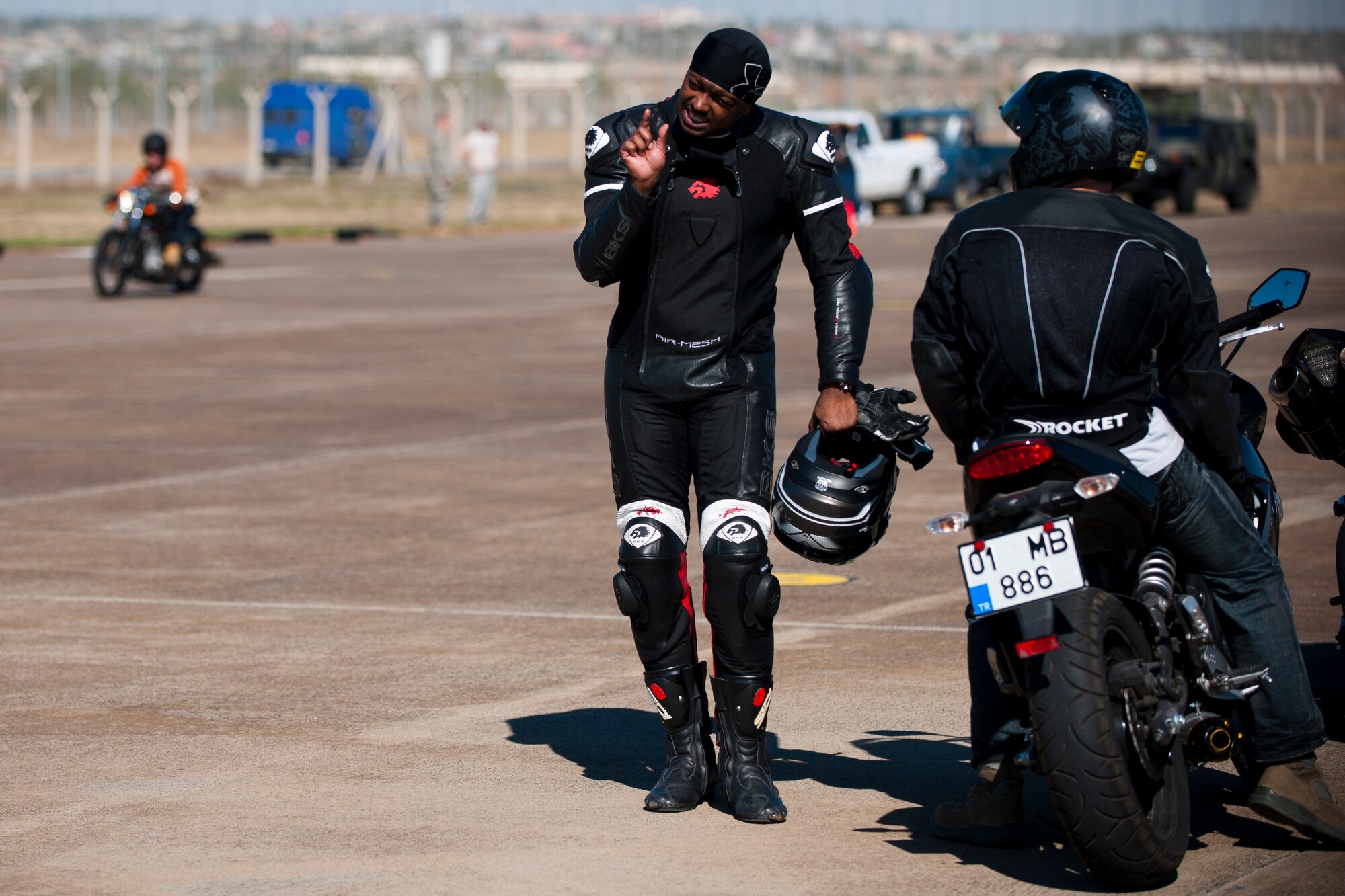 Participants discuss their driving during the skills course portion of the Motorcycle Rodeo Oct. 21, 2011, at Incirlik Air Base, Turkey. The 39th Air Base Wing Safety Office hosted the rodeo and designed the course to give riders a chance to practice curves and other maneuvers at higher speeds than the basic riders course. (U.S. Air Force photo by Tech. Sgt. Michael B. Keller/Released)