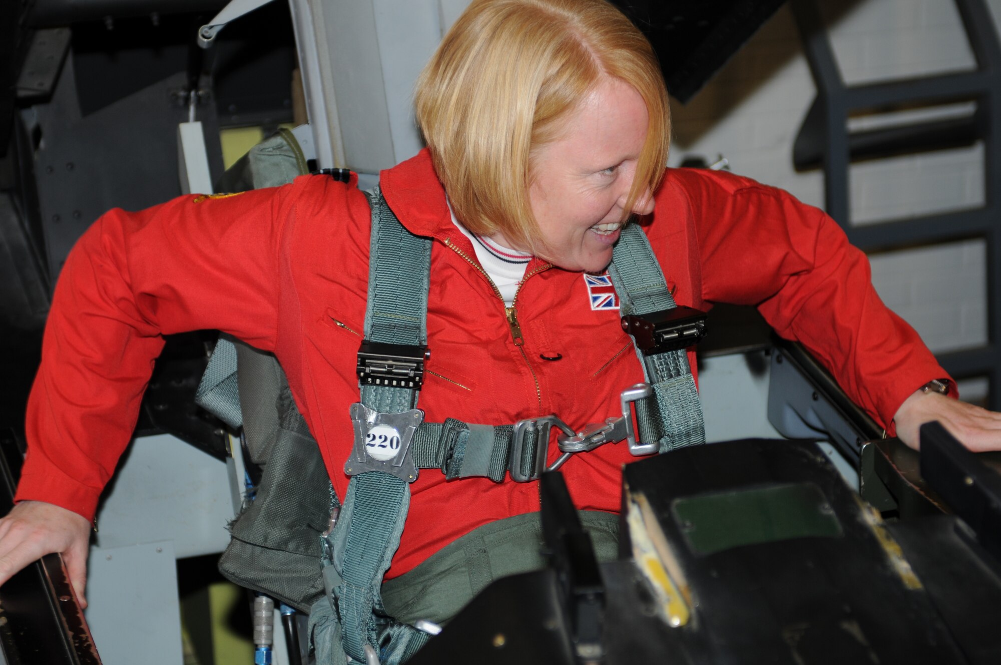 RAF Flight Lt. Kirsty Stewart climbs into an F-16 egress trainer, Oct. 20. Stewart, a member of the United Kingdom’s Red Arrows aerial demonstration team, flew with the international F-16 training wing, Oct. 21. (U.S. Air Force photo/Maj. Gabe Johnson)