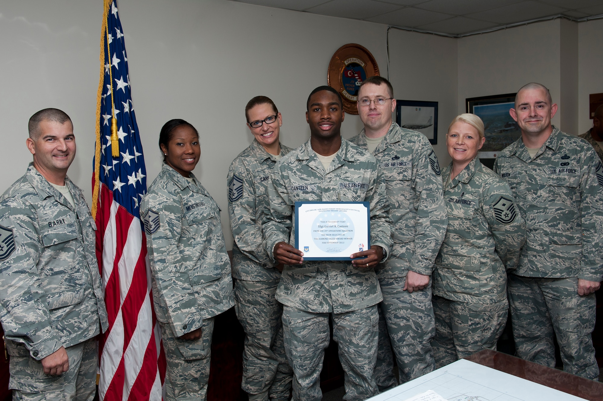 Staff Sgt. Garriet Canteen, 39th Operations Squadron, is presented the Diamond Sharp Award by members of the Incirlik First Sergeants Council Oct. 21, 2011, at Incirlik Air Base, Turkey. Canteen earned the monthly award for September by distinguishing himself through outstanding professionalism, performance and display of the Air Force core values. (U.S. Air Force photo by Tech. Sgt. Michael B. Keller/Released)
