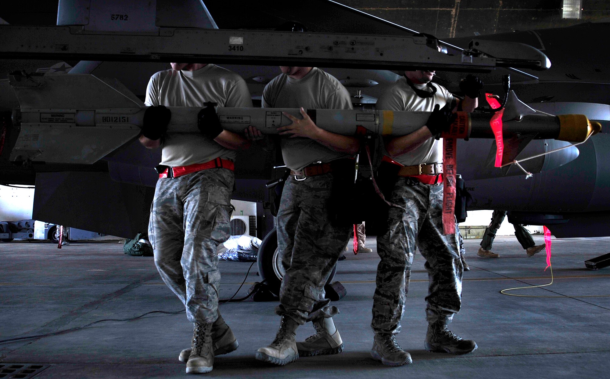 Airmen from the 125th Expeditionary Fighter Squadron load a heat-seeking missile onto an F-16 Fighting Falcon Oct. 1, 2011. The squadron deployed in support of Operation New Dawn and will provide close air support for more than 40,000 troops leaving Iraq by the end of the year. The 125th EFS is comprised of F-16s, pilots, maintenance specialists and support personnel from the Oklahoma Air National Guard’s 138th Fighter Wing in Tulsa, Okla. The squadron also includes members from the Ohio Air National Guard’s 180th Fighter Wing in Toledo, Ohio, and the Arizona Air National Guard’s 162nd Fighter Wing in Tucson, Ariz. (U.S. Air Force photo/Master Sgt. Cecilio Ricardo)