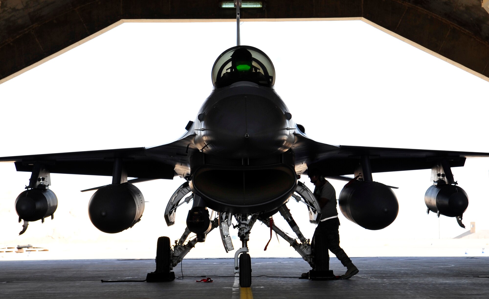 A weapons loader from the 125th Expeditionary Fighter Squadron performs a post flight check on an F-16 Fighting Falcon after its arrival in Iraq Oct. 1, 2011. The squadron deployed in support of Operation New Dawn and will provide close air support for more than 40,000 troops leaving Iraq by the end of the year. The 125th EFS is comprised of F-16s, pilots, maintenance specialists and support personnel from the Oklahoma Air National Guard’s 138th Fighter Wing in Tulsa, Okla. The squadron also includes members from the Ohio Air National Guard’s 180th Fighter Wing in Toledo, Ohio, and the Arizona Air National Guard’s 162nd Fighter Wing in Tucson, Ariz. (U.S. Air Force photo/Master Sgt. Cecilio Ricardo)