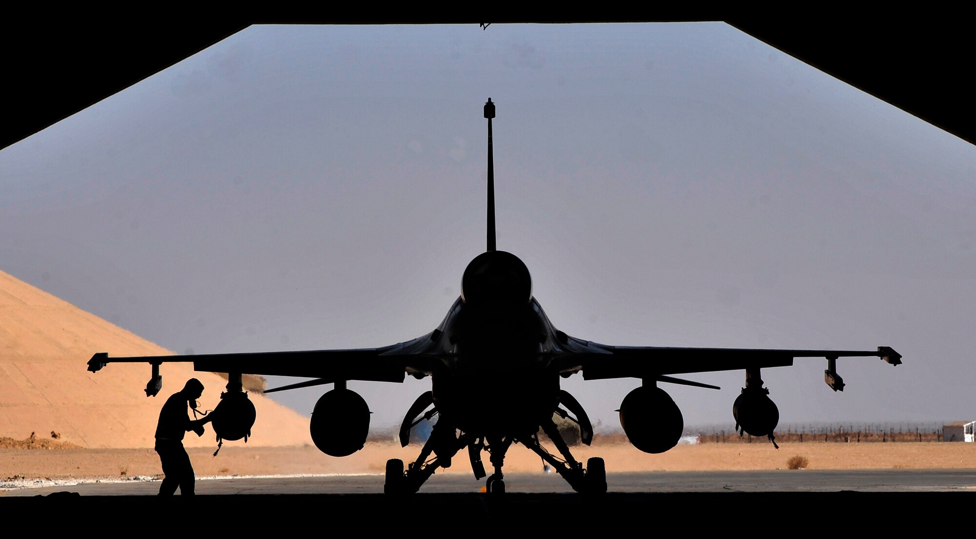 A weapons loader from the 125th Expeditionary Fighter Squadron performs a post flight check on an F-16 Fighting Falcon after its arrival in Iraq Oct. 1, 2011. The squadron deployed in support of Operation New Dawn and will provide close air support for more than 40,000 troops leaving Iraq by the end of the year. The 125th EFS is comprised of F-16s, pilots, maintenance specialists and support personnel from the Oklahoma Air National Guard’s 138th Fighter Wing in Tulsa, Okla. The squadron also includes members from the Ohio Air National Guard’s 180th Fighter Wing in Toledo, Ohio, and the Arizona Air National Guard’s 162nd Fighter Wing in Tucson, Ariz. (U.S. Air Force photo/Master Sgt. Cecilio Ricardo)