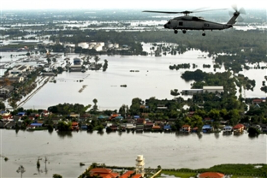 Members of a U.S. Marine Corps humanitarian assessment team and Royal Thai troops fly in a SH-60F Sea Hawk helicopter to assess flood damage in Bangkok, Thailand, Oct. 23, 2011. The Sea Hawk crew is assigned to Helicopter Anti-Submarine Squadron 14.