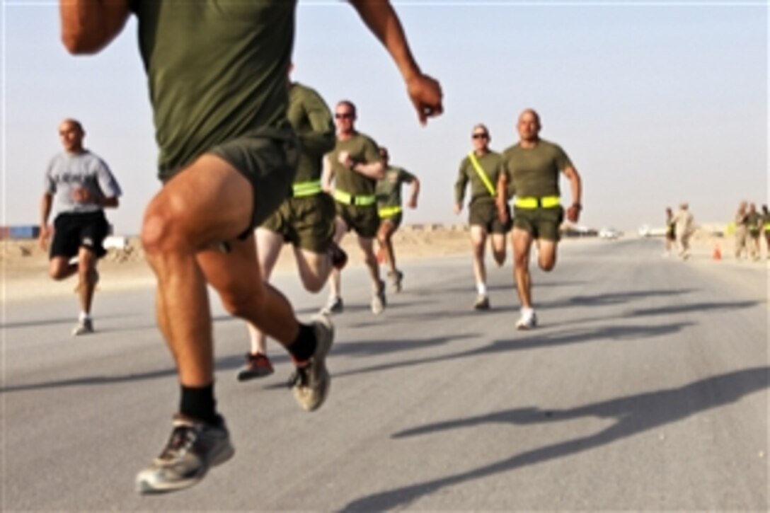 Runners dash toward the finish line during the 400-meter run portion of the 2nd Marine Logistics Group's Iron Man Competition on Camp Leatherneck, Afghanistan, Oct. 22, 2011. The event tested the physical resolve of troops across the base.