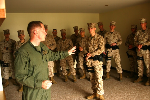 Sgt. Kyle C. Hill, Provost Marshal’s Office Special Reaction Team leader, teaches a group of military policemen about basic close quarter tactics and how to put them into action during a training exercise here Tuesday. The military policemen worked in collaboration with PMO’s Special Reaction Team in order to learn basic close quarters combat methods and how to use them while incorporating everyday military policeman tactics.