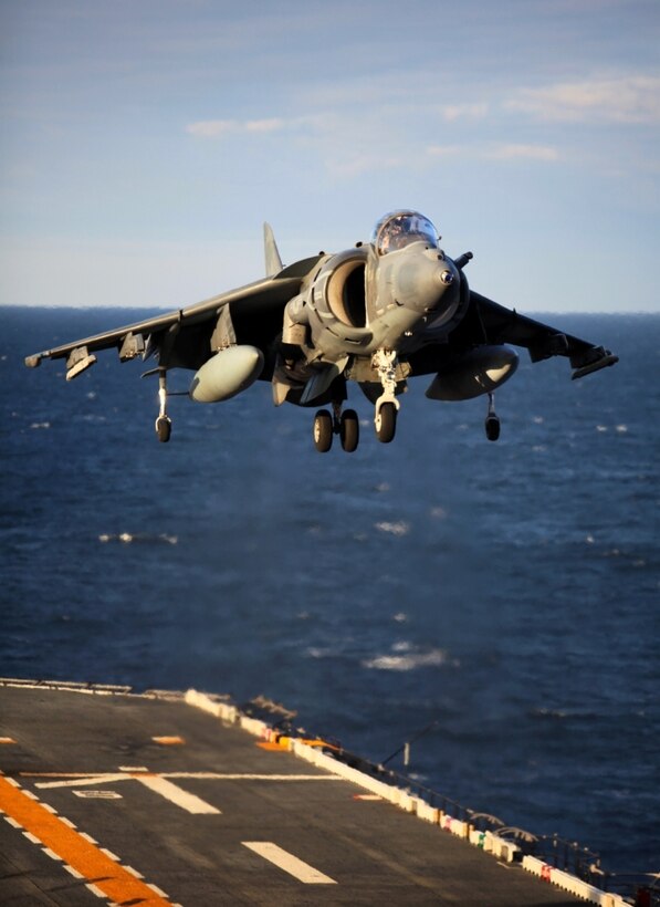 An AV-8B Harrier commences a vertical landing on the flight deck off the USS Iwo Jima during deck landing qualifications as part of the Amphibious Squadron 8 (PHIBRON 8) / 24th Marine Expeditionary Unit Integration Training (PMINT) Oct. 24, 2011. PMINT will take place Oct. 24 to Nov. 3 and is focused on building the Navy-Marine Team and establish the working relationships and practices necessary to conduct operations from the sea. The AV-8B Harriers are a detachment from VMA-542 based at Marine Corps Air Station Cherry Point, N.C., and comprise part of Marine Medium Tiltrotor Squadron VMM-261 (Rein), which is the Aviation Combat Element for the 24th MEU.::r::::n::::r::::n::::r::::n::