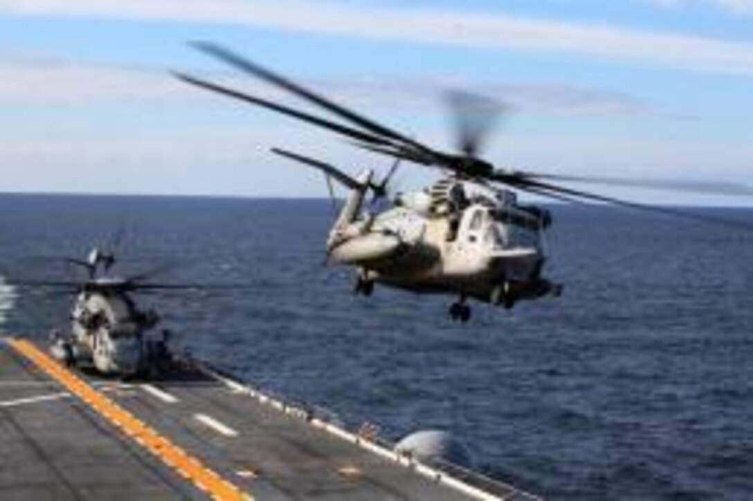 Two CH-53E Super Stallions take off from the USS Iwo Jima during deck landing qualifications as part of the Amphibious Squadron 8 (PHIBRON 8) / 24th Marine Expeditionary Unit Integration Training (PMINT) Oct. 24, 2011. PMINT will take place Oct. 24 to Nov. 3 to build the Navy-Marine Team and establish the working relationships and practices necessary to conduct operations from the sea. The CH-53E helicopters are a detachment from HMH-464 based at Marine Corps Air Station New River, N.C., and comprise part of Marine Medium Tiltrotor Squadron VMM-261 (Rein), which is the Aviation Combat Element for the 24th MEU.
