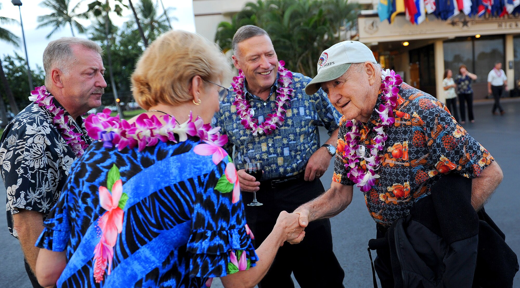 Mrs.  Heidi Wild, Pacific Air Forces Civilian Advisory Council secretary, shakes hands with Lt. Gen. (ret.) Winton “Bones” Marshall, Korean War Ace and former Vice Commander in Chief for PACAF from 1974-1975, as Mayor of Honolulu Peter Carlisle (left) and Pacific Air Forces Commander Gen. Gary North look on at the base operations flightline, Joint Base Pearl Harbor-Hickam, Hawaii, Oct. 5.  The group attended a special event for the Fall Commanders and Command Chiefs Warfighter Conference in which this year’s theme paid homage to military heritage.  The conference, held Oct. 5-7, was designed to expand and enhance the relationship between uniformed servicemembers in the Pacific region, and to develop the growing relationships with civilian partners.  (U.S. Air Force photo/Tech. Sgt. Jerome S. Tayborn)