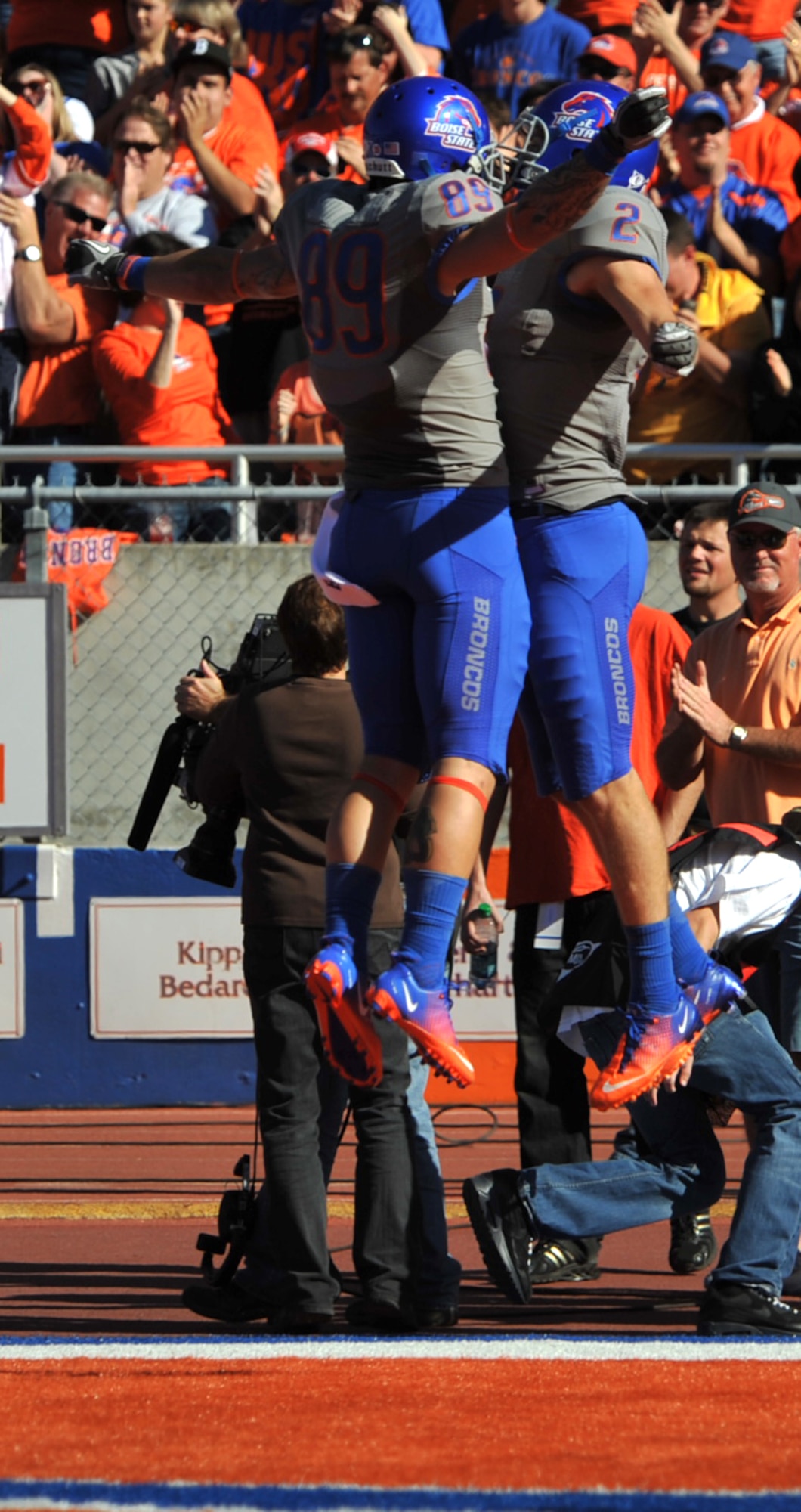 Boise State University football players celebrate after a touchdown against the Air Force Academy Falcons at on Oct. 22, 2011, at Boise State University’s Bronco Stadium in Boise, Idaho. The Broncos are undefeated this season and moved up to number four in the Bowl Championship Series rankings after this game. (U.S. Air Force photo by Airman 1st Class Heather Hayward)