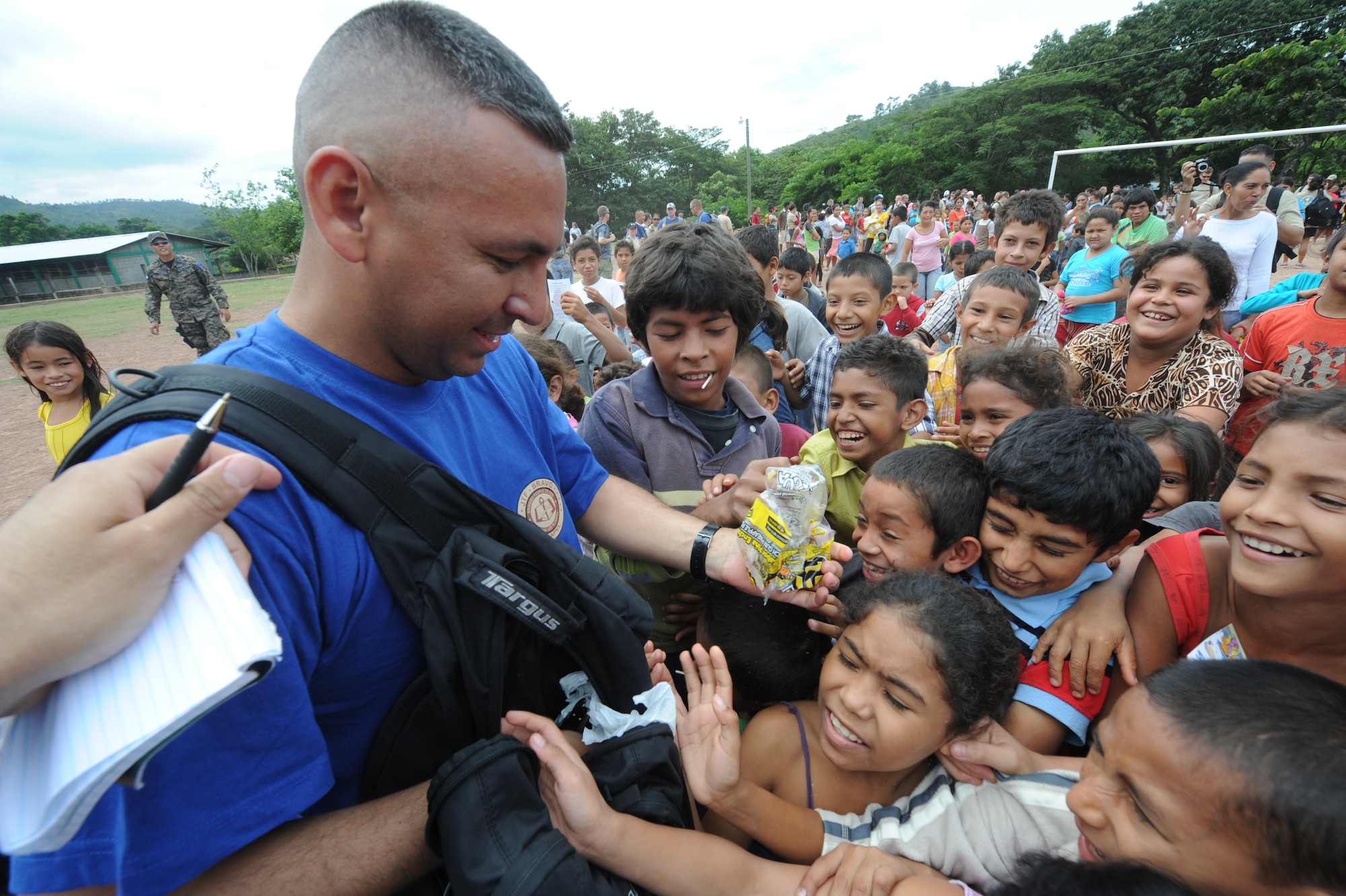 Master Sgt. Josue Guzman, from Joint Task Force-Bravo ports and planning, hands out candy to children of El Sitio Oct. 22, 2011, near Soto Cano Air Base, Honduras. Nearly 150 Joint Task Force-Bravo personnel hiked three miles to deliver food to the small village. (U.S. Air Force photo/Tech. Sgt. Matthew McGovern)