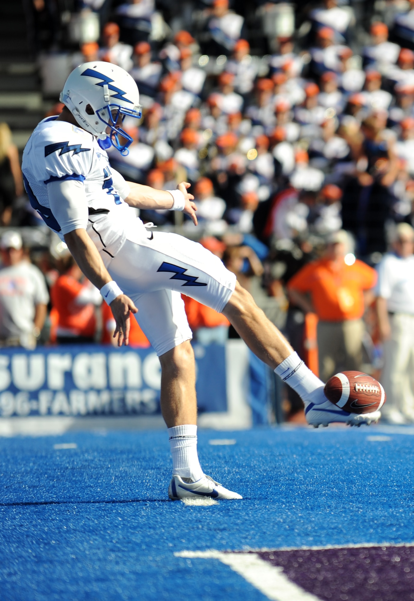 Air Force Academy cadet David Baska punts the football away on the “smurf turf” of Boise State’s Bronco stadium in Boise, Idaho, during the Falcons 37-26 loss to Broncos Oct. 22, 2011. The future Air Force officers were cheered as they came on the field by the BSU fans who normally boo the opposing team as they come onto the blue. (U.S. Air Force photo by 2nd Lt. David Liapis)