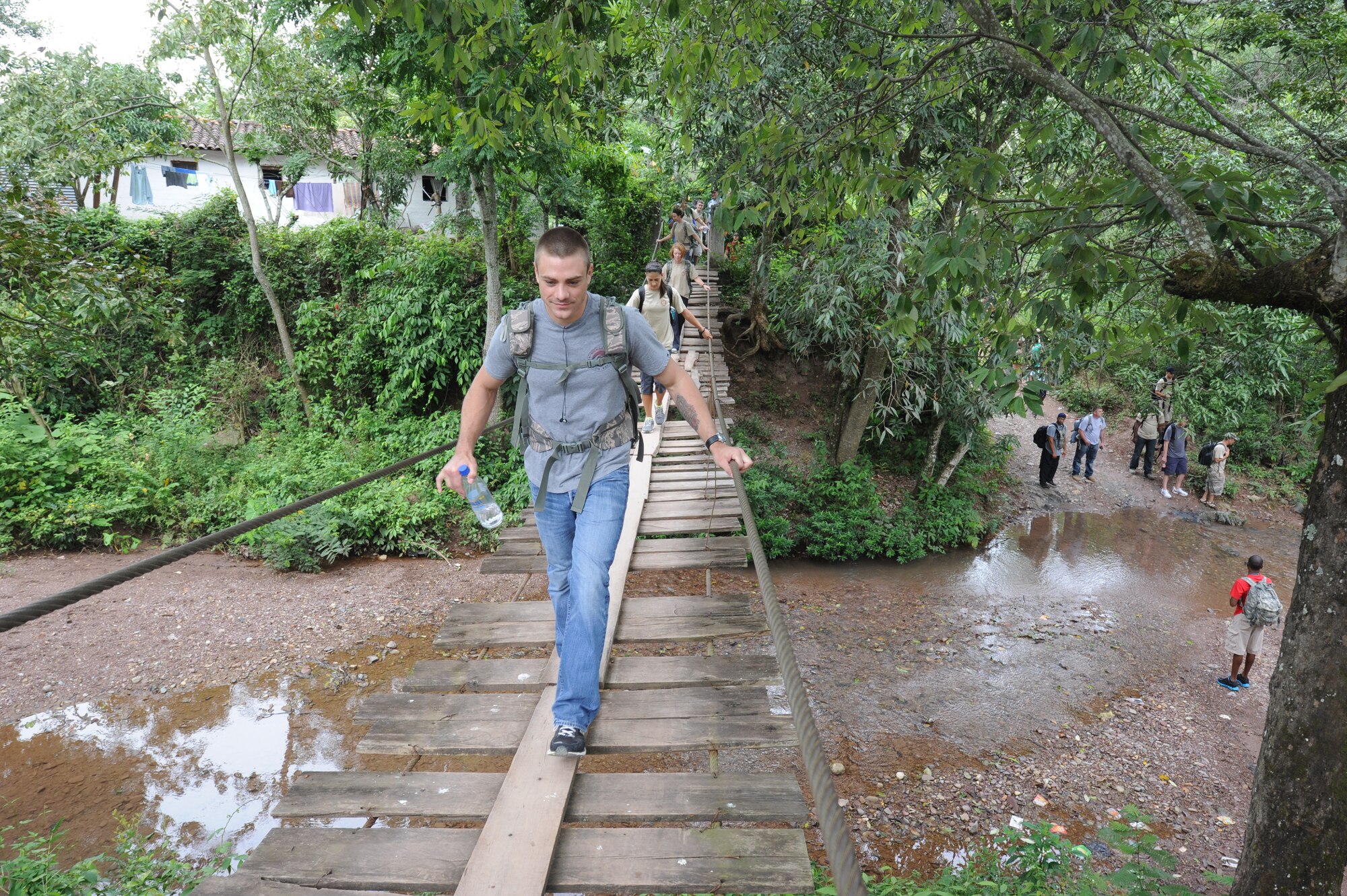Staff Sgt. Christopher Mavron, Joint Task Force-Bravo contracting officer, crosses a rope bridge Oct. 22, 2011 at El Sitio, near Soto Cano Air Base, Honduras. Nearly 150 Joint Task Force-Bravo personnel hiked three miles to deliver food to the small village. (U.S. Air Force photo/Tech. Sgt. Matthew McGovern)