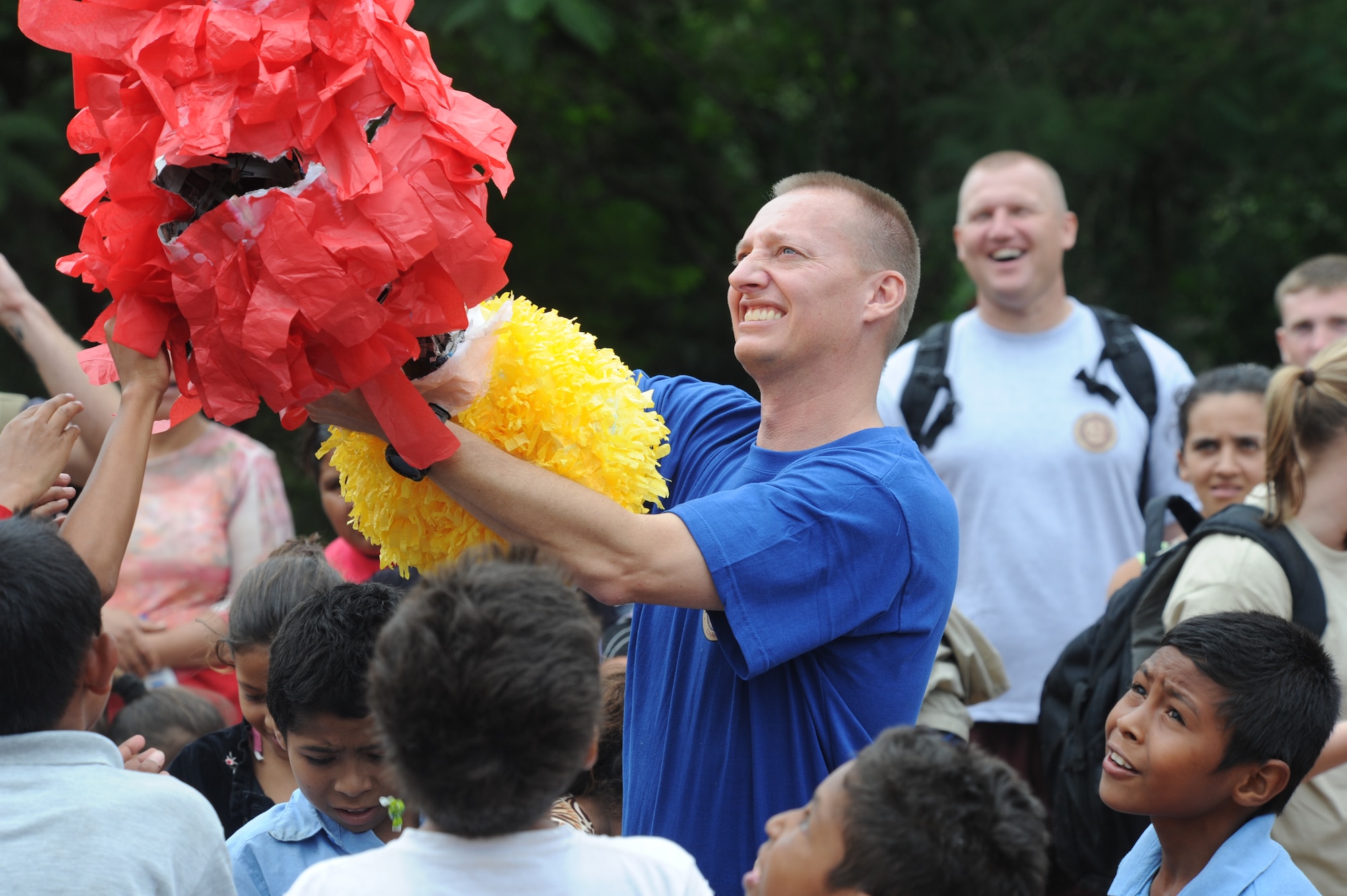 Chaplain (Capt.) Mark Williams, JTF-Bravo Command Chaplain, shakes the remaining candy out of a pinata Oct. 22, 2011 at El Sitio, near Soto Cano Air Base, Honduras. Nearly 150 Joint Task Force-Bravo personnel hiked three miles to deliver food to the small village. (U.S. Air Force photo/Tech. Sgt. Matthew McGovern)