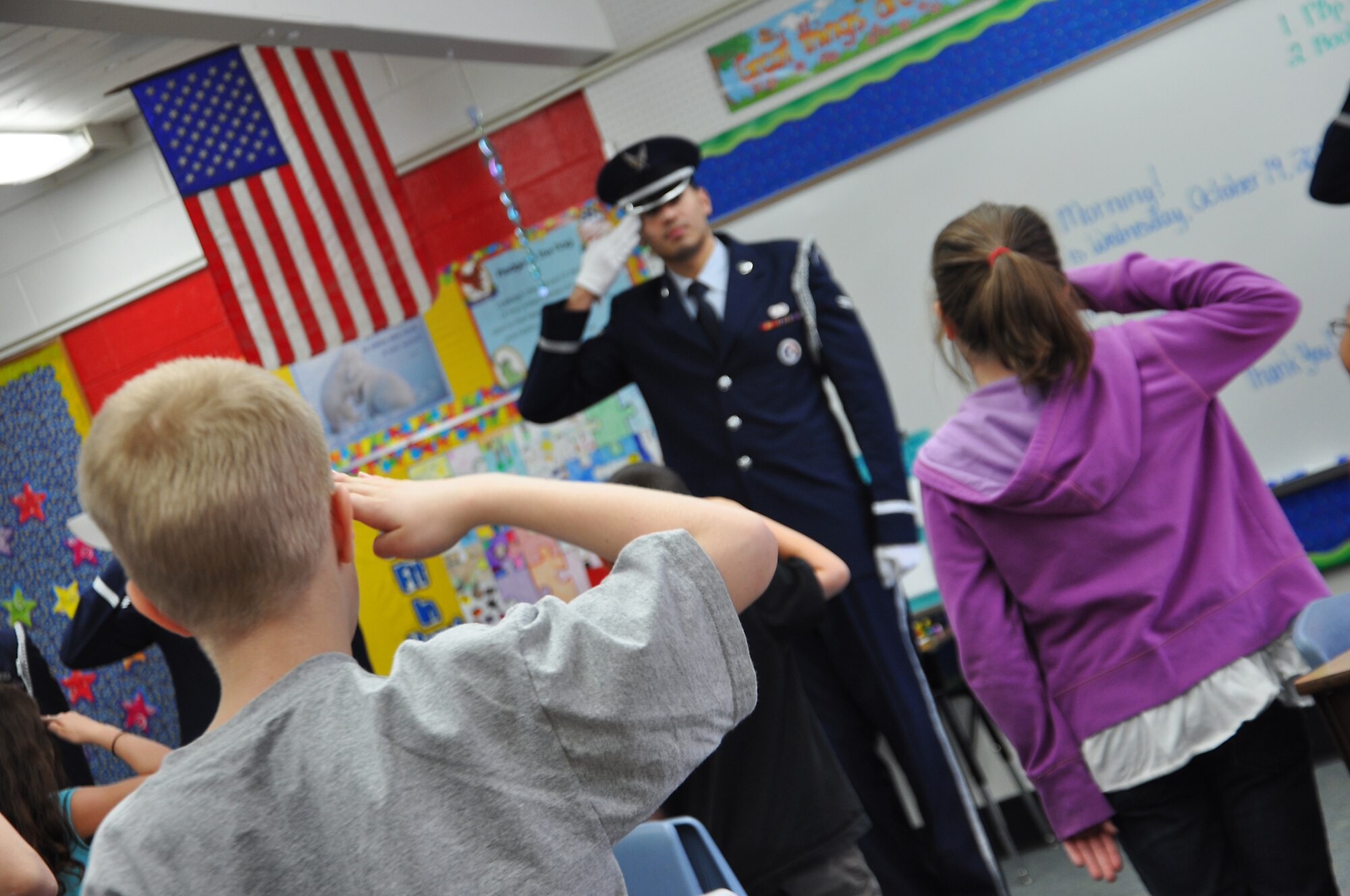 ANCHORAGE, Alaska -- A class of third grade students mimic Airman 1st Class Jose Mejia as he demonstrates how to properly render a salute Oct. 19. Joint Base Elmendorf-Richardson honor guard members visited Abbott Loop Elementary school to demonstrate proper flag folding procedures as well as other military movements to students. (U.S. Air Force photo/Senior Airman Cynthia Spalding) 