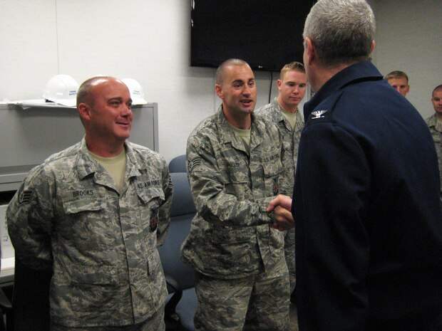 Staff Sgt. Michael Puglisi, a firefighter in the 166th Civil Engineer Squadron, Del. Air National Guard, is greeted by 166th Airlift Wing Commander Col. Jonathan Groff on Oct. 24, 2011 at the New Castle ANG Base, Del., upon the arrival home of a group of seven unit firefighters who completed a six-month combat zone deployment to Southwest Asia where most were assigned to the 405th Expeditionary CES fire department. (U.S. Air Force photo/Tech. Sgt. Benjamin Matwey)