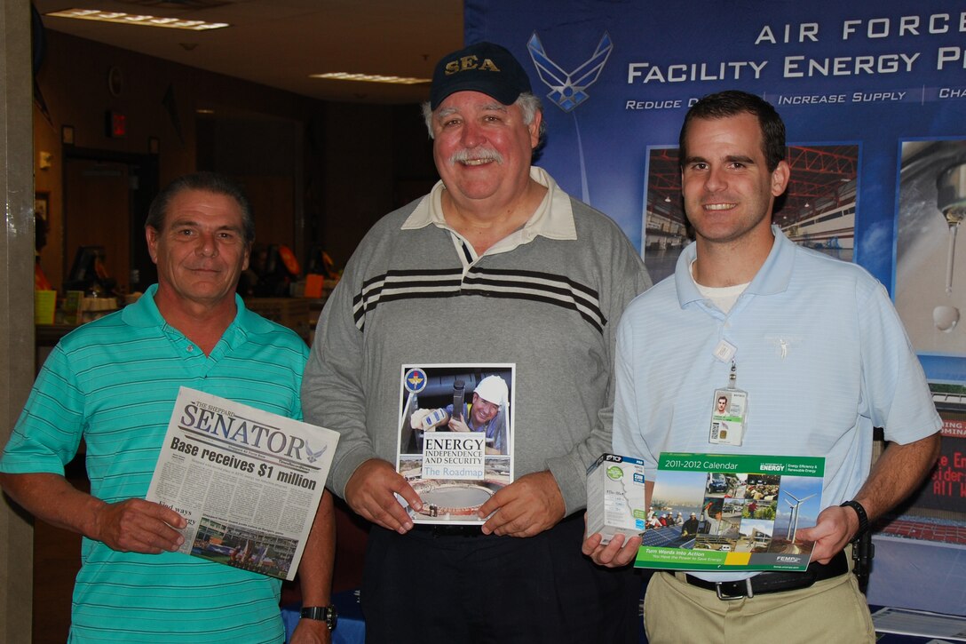 Mr. Edward Jordan, Base Energy Manager, Mr. Glynn Batla, Resource Efficiency Manager, and Mr. Michael Gaffney, DS2 construction inspector, set up an educational booth for Airmen at the Mesquite Dining Facility, Sheppard Air Force Base Oct. 25, to distribute Compact Fluorescent Light bulbs and talk about energy savings. They have collaborated on a basewide lighting retrofit project for the past year.