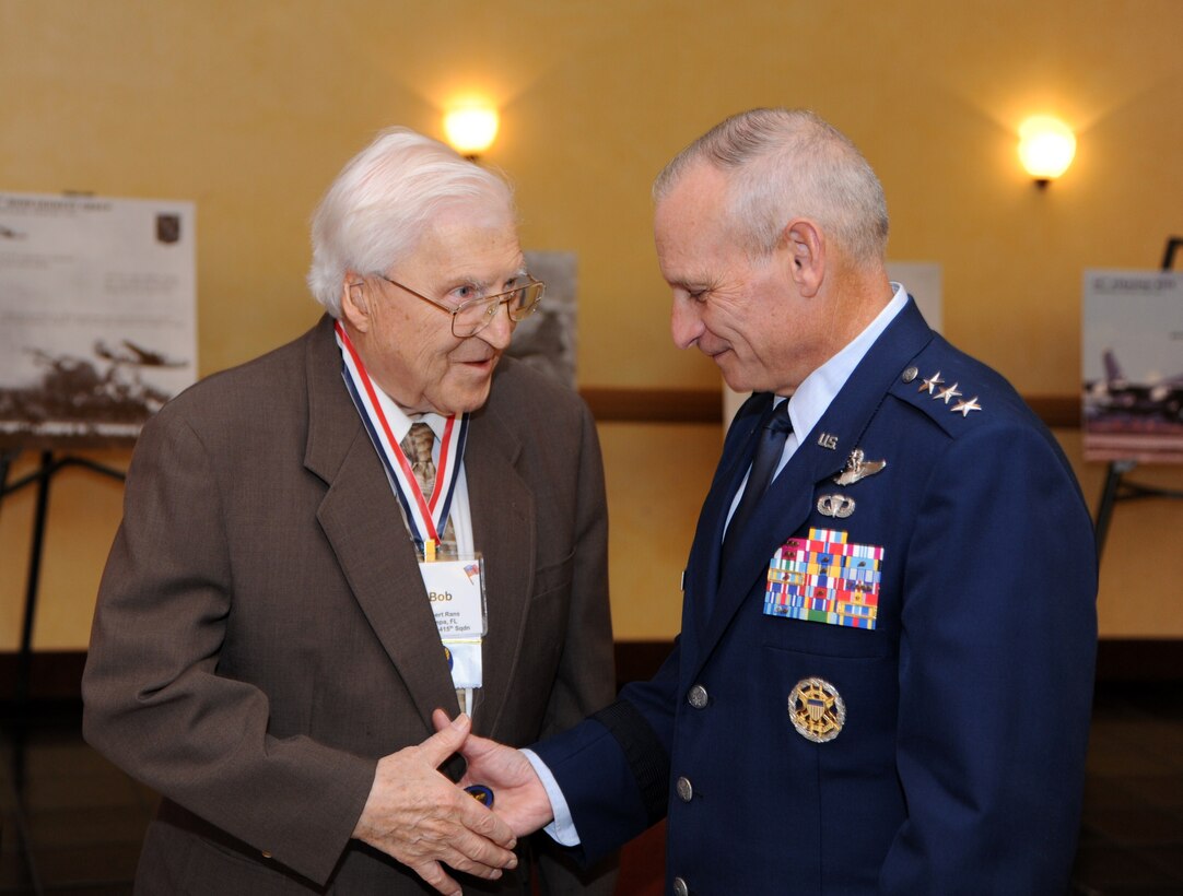 BARKSDALE AIR FORCE BASE, La. – Lt. Gen. Jim Kowalski, commander of Air Force Global Strike Command, presents a coin to Tech. Sgt. (ret) Robert "Bob" Rans during the 98th Bombardment Group reunion. The event honored World War II veterans who participated in the Ploesti Raids in Romania from 1943-1944.  Rans was involved in the first bombing missions of Ploesti oil refineries to cut off fuel supplies to German enemy powers during the war. (U.S. Air Force photo/Master Sgt. Corey A. Clements)