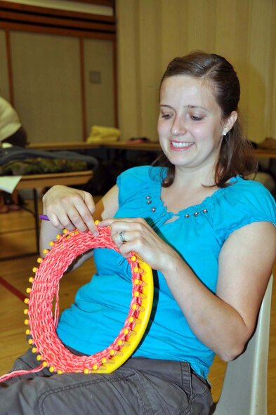 Lindsey Cortes, 29, of Mentone, Calif., makes a hat during a weekly volunteer session with Women of Faith in Redlands, Calif., for shipment to Afghanistan as part of humanitarian cargo through the Denton Amendment, a U. S. government program that offers free shipment for this cargo via military aircraft on a space available basis.  The group also donates to local hospitals.  (U.S. Air Force photo/Linda Welz)