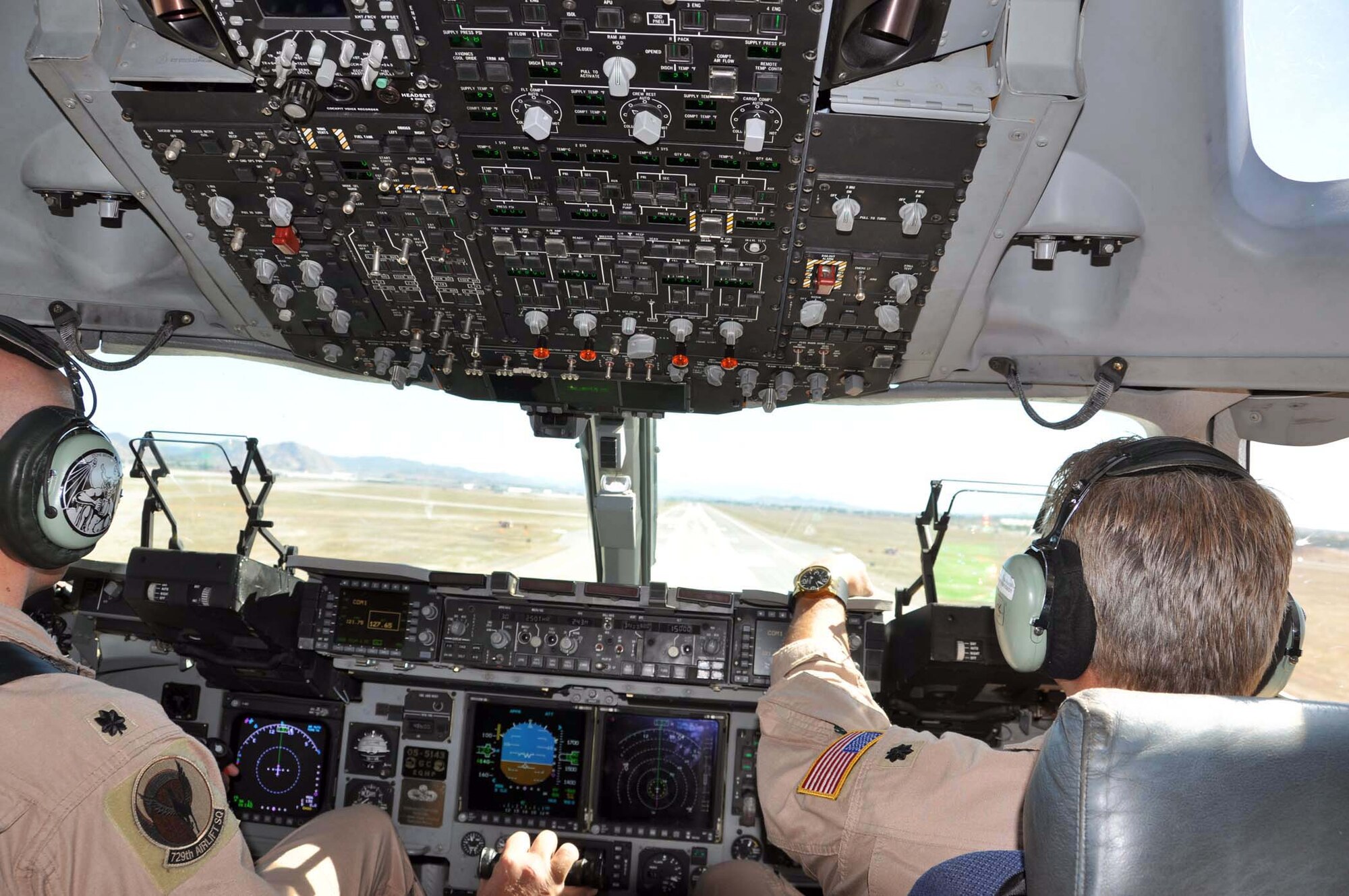 Lt. Col. Tim Harris (left) and Lt. Col. Keith Guillotte, 729th Airlift Squadron pilots land a C-17 Globemaster III at March Field October 8, 2011, after a week-long mission to deliver humanitarian supplies to orphans in Kabul, Afghanistan.  The cargo, donated by Women of Faith in Redlands, Calif., was shipped through the Denton Amendment program, a U.S. government program that allows humanitarian supplies to be shipped on military aircraft free of charge on a space available basis. (U.S. Air Force photo/Master Sgt. Linda Welz)