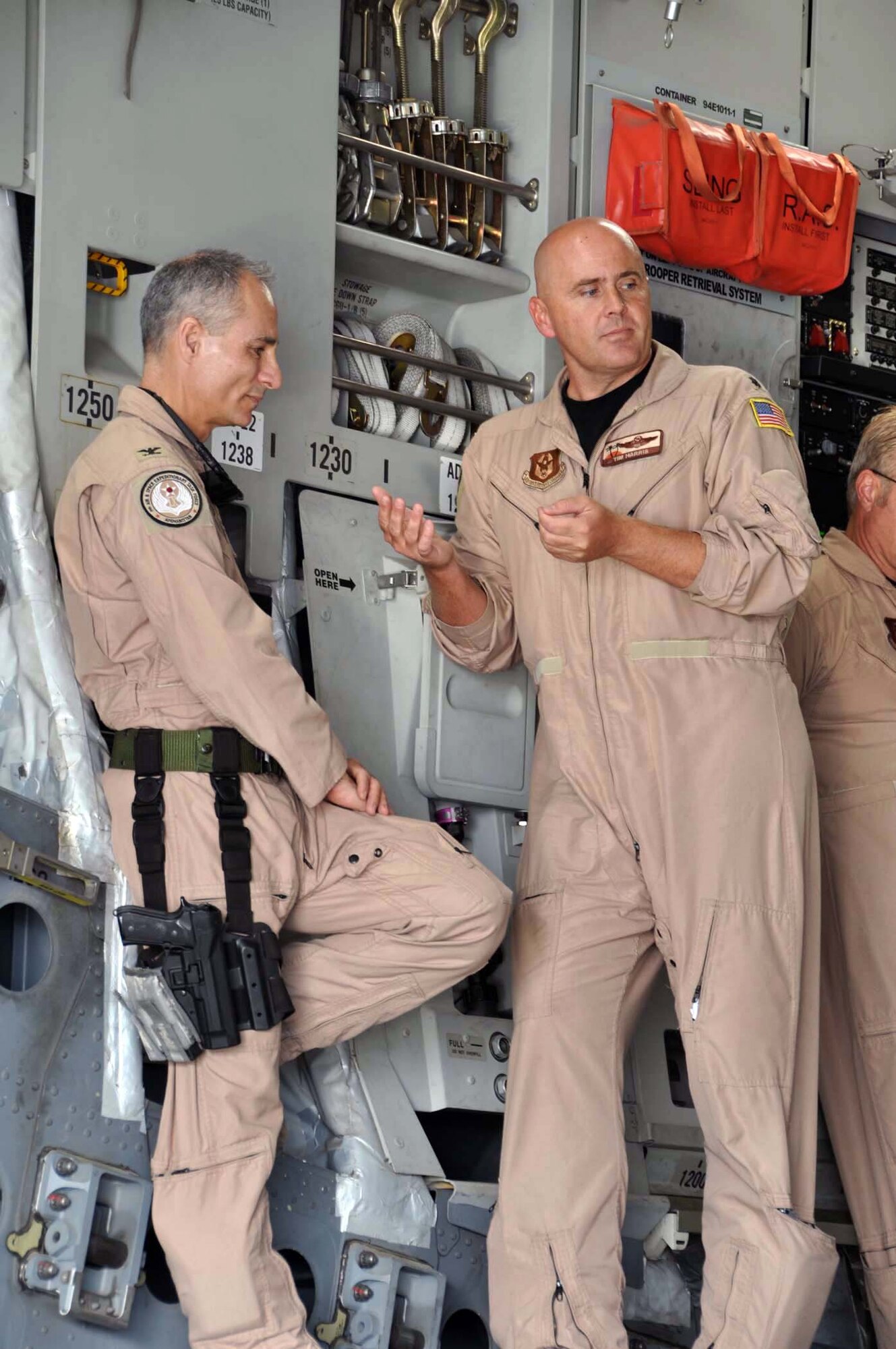 Lt. Col. Tim Harris, 729th Airlift Squadron pilot and aircraft commander, discusses the mission with deployed 452nd Air Mobility Wing commander, Col. Udo McGregor, upon Harris' arrival at Kabul International Airport, Afghanistan, October 4, 2011.  Team March transported cargo, donated by Women of Faith in Redlands, Calif., to the war-torn nation through the Denton Amendment program, a U.S. government program that allows humanitarian supplies to be shipped on military aircraft free of charge on a space available basis. (U.S. Air Force photo/Master Sgt. Linda Welz)