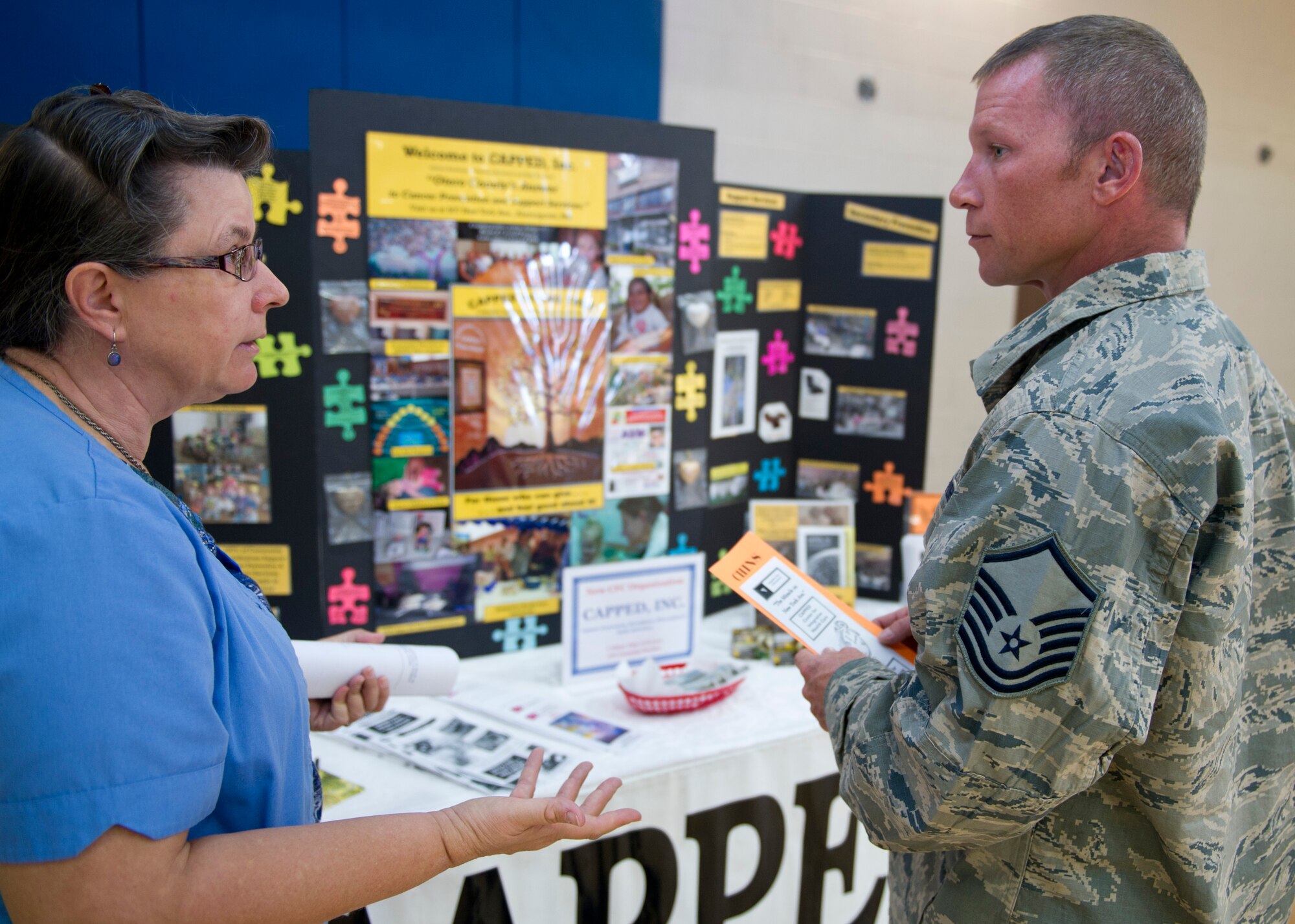 HOLLOMAN AIR FORCE BASE, N.M. -- Teresa VanWinkle of Cancer Awareness, Prevalence, Prevention and Early Detection Inc., speaks with U.S. Air Force Master Sgt. Mark Thomas, 49th Civil Engineer Squadron, during the 2011 Combined Federal Campaign Kick-off Oct. 18, 2011, at the Domenici Fitness and Sports Center. The CFC event gave several local organizations a chance to showcase their mission and provide Team Holloman with an opportunity to contribute to their cause. (U.S. Air Force photo by Senior Airman Veronica Stamps/Released)