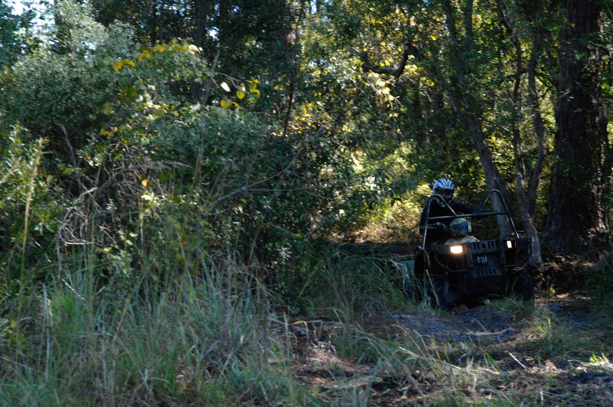 U.S. Air Force Airman 1st Class Caitlan Bunn, 38th Rescue Squadron aircrew flight equipment journeyman, sharpens her four-wheeling skills Oct. 21, 2011, at Moody Air Force Base, Ga. When deployed, Bunn is expected to know how to operate various all-terrain vehicles. (U.S. Air Force photo by Senior Airman Brigitte N. Brantley/Released)