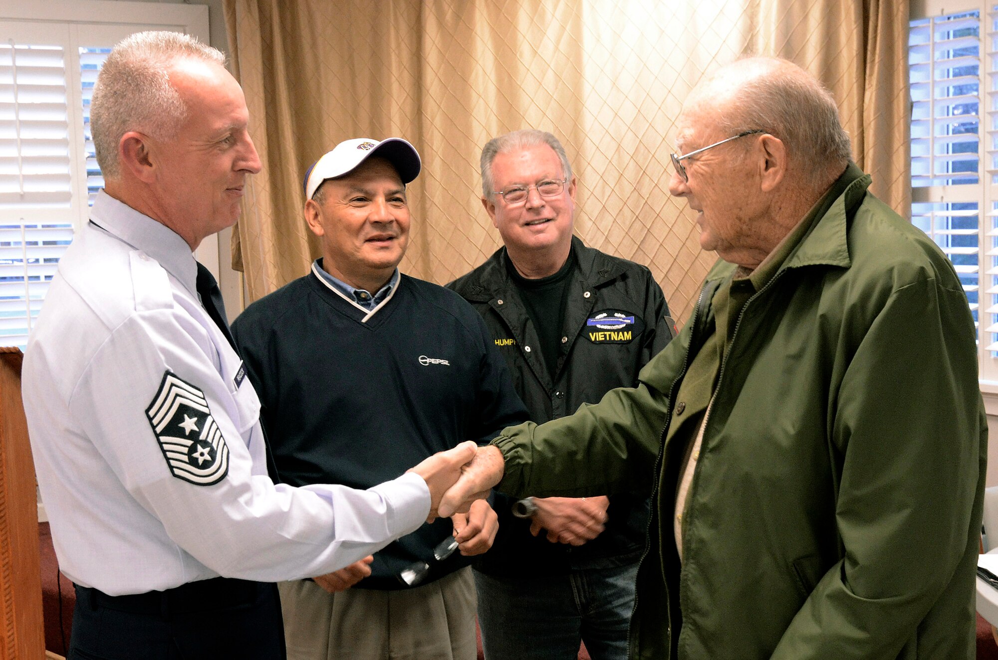 Chief Master Sgt. Wendell Peacock, Command Chief for the 94th Airlift Wing at Dobbins Air Reserve Base, greets Marine veteran Francis Wolfe, a member of the Georgia Vietnam Veterans Alliance in Marietta, Ga., Oct. 20. The Marietta Chapter of the alliance is dedicated to provide quality services and support to veterans to help with their self-esteem and encourage them to be self reliant.   (U.S. Air Force photo/ Brad Fallin)