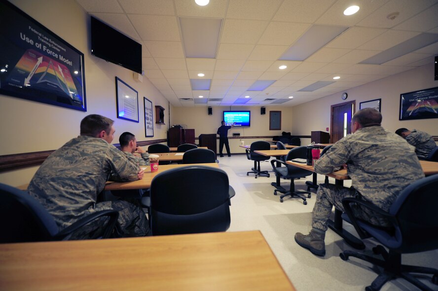 Airmen from the 4th Security Forces Squadron complete the classroom portion of Use of Force training on Seymour Johnson Air Force Base, N.C., Oct. 24, 2011. The annual three-part training covers when and how to use certain types of force from strong verbal commands to deadly.(U.S. Air Force photo by Senior Airman Rae Perry)