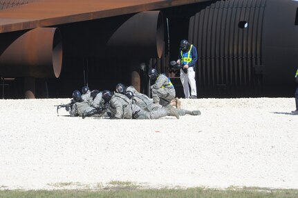 902nd Security Forces Squadron personnel lie down and fire as they approach a hostile fire zone. 902nd SFS personnel deployed to Camp Talon on Randolph Air Force Base Oct. 18 for a field training exercise to hone the expeditionary skills they need to deploy. (U.S. Air Force photo/Rich McFadden) (released)